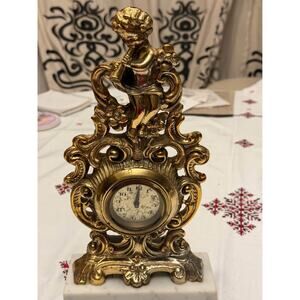 Vintage Figural Mantel Clock, Gilded, Featuring a Cherub Figure Playing a Flute.